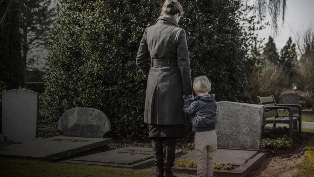 wrongful death photo of a family mourning in a graveyard